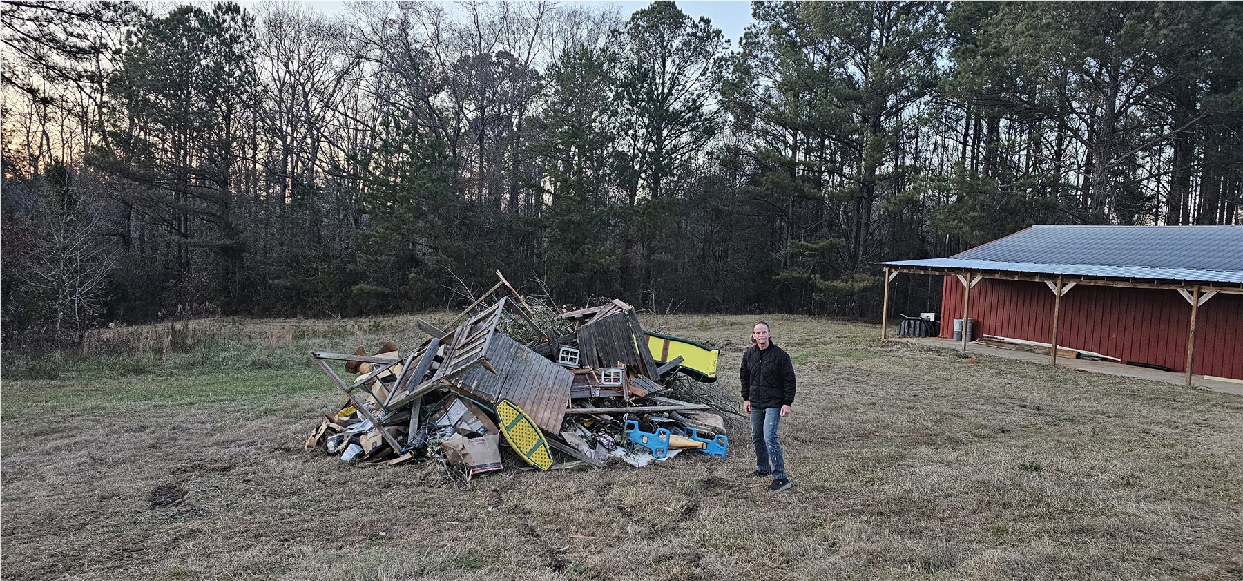 Build-site cleanup beside the barn