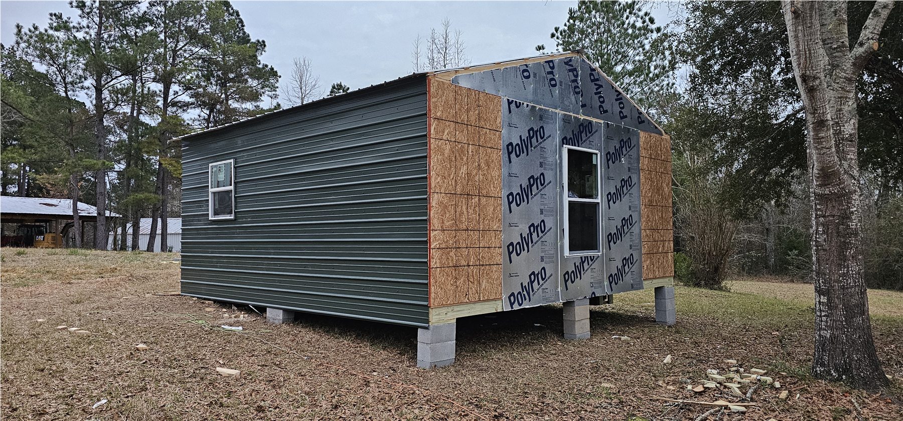 Dark siding installed on the tiny house
