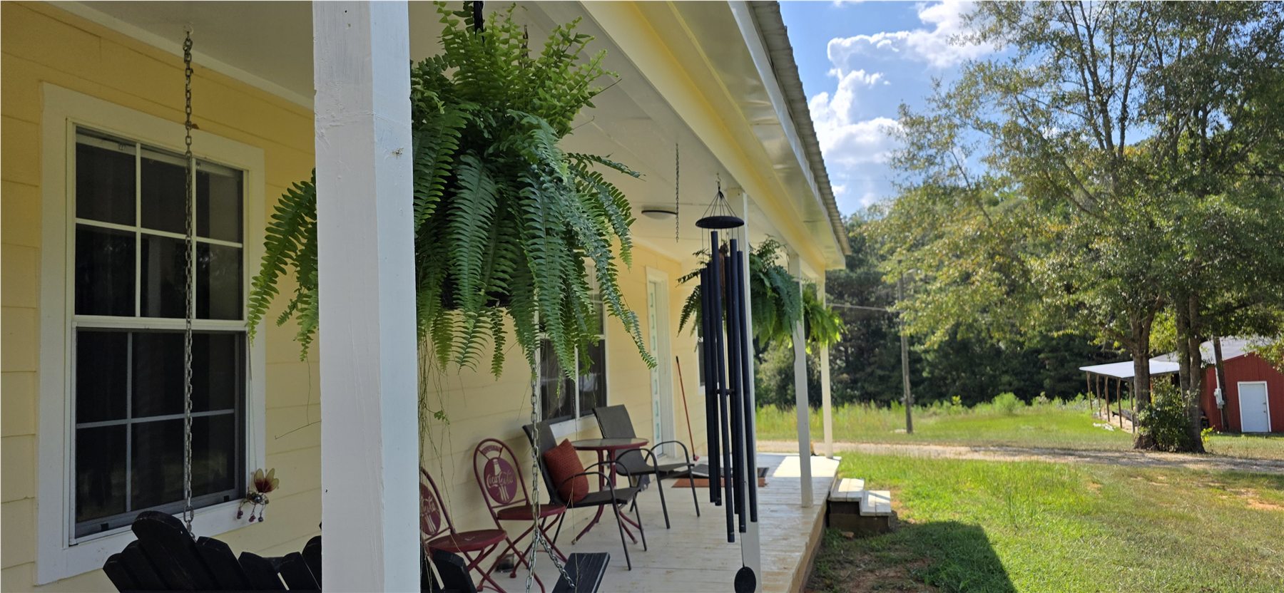 Long covered porch and hanging ferns