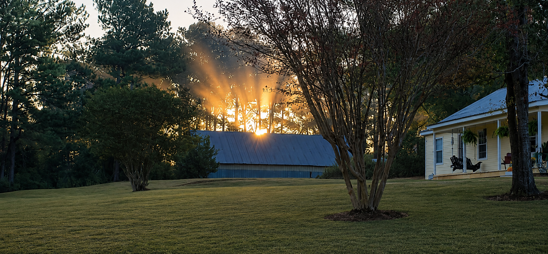 AI-enhanced sunset view of the main house and neighboring barn